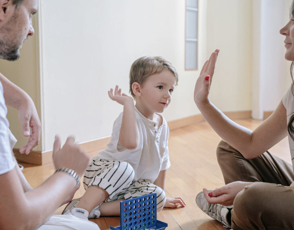boy high fiving caregiver after playing a game