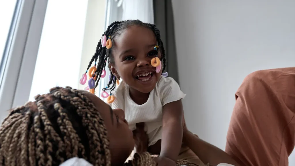 child playing with mother