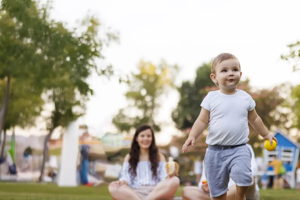 boy playing with caregiver in park