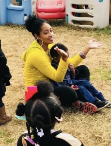 camille bennett sitting with children at care center