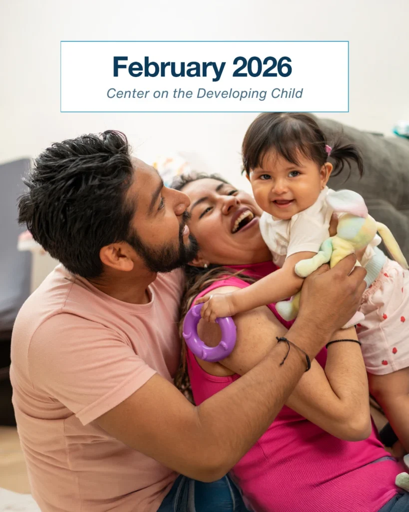 young child being held by mom and dad.