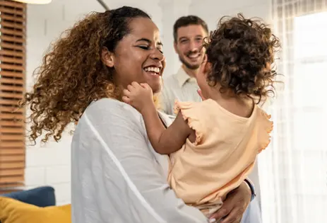 caregivers and young child playing