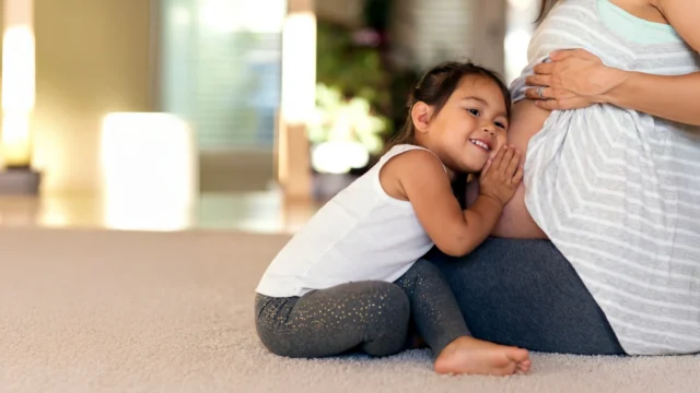 pregnant caregiver with child.