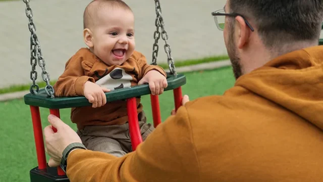 baby-in-swing-caregiver.