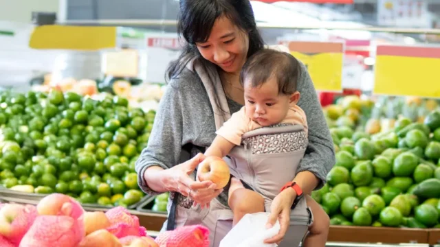 mother and child grocery shopping for fresh produce.
